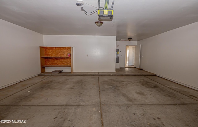 garage with a garage door opener and electric water heater