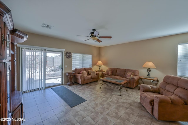 living area featuring visible vents, ceiling fan, and light tile patterned flooring