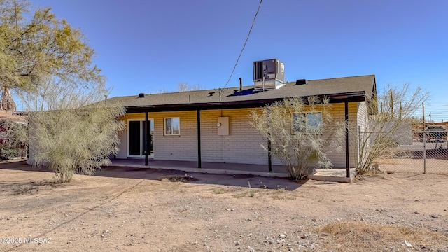 back of property featuring a patio, fence, and central AC