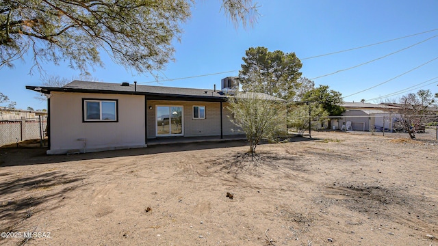back of house with fence