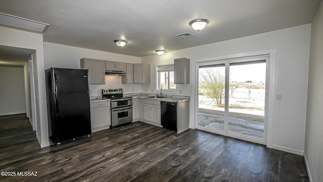kitchen with visible vents, under cabinet range hood, gray cabinets, black appliances, and a sink