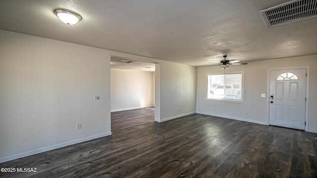 foyer with dark wood-style floors, visible vents, baseboards, and ceiling fan