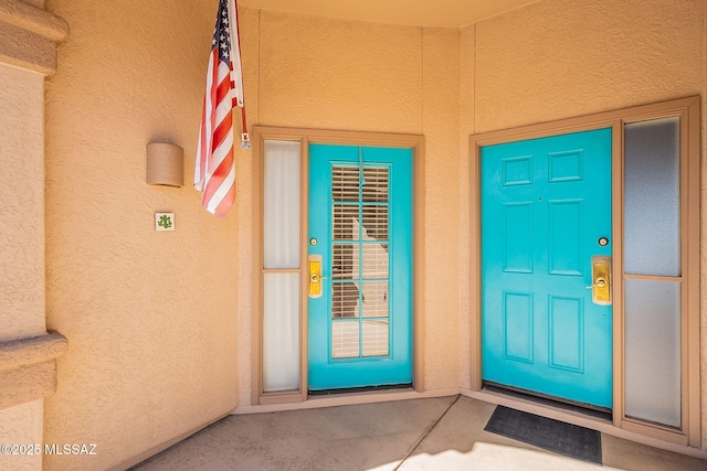 doorway to property with stucco siding