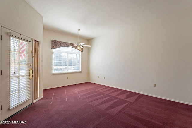 empty room with ceiling fan, carpet flooring, and baseboards