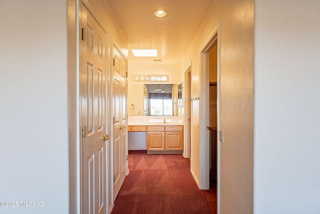 hallway featuring a sink