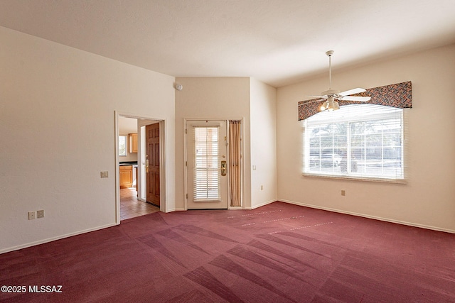 unfurnished room with baseboards, a healthy amount of sunlight, ceiling fan, and carpet flooring