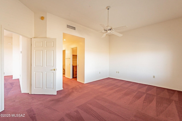 empty room featuring high vaulted ceiling, carpet, visible vents, and a ceiling fan