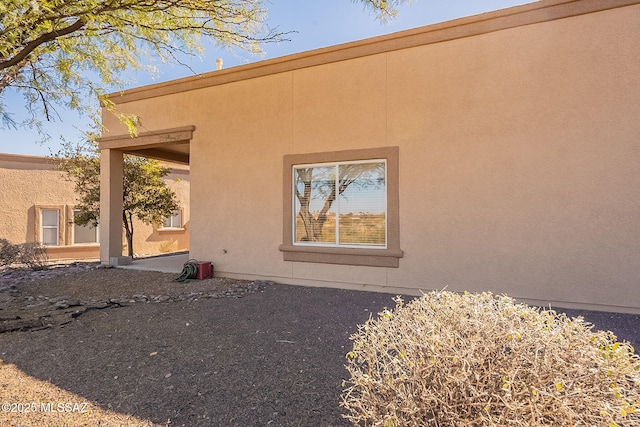 back of house with stucco siding