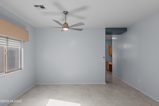 unfurnished room with a ceiling fan, baseboards, and visible vents