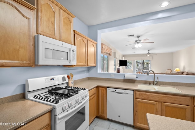 kitchen featuring light tile patterned floors, white appliances, a sink, visible vents, and light countertops