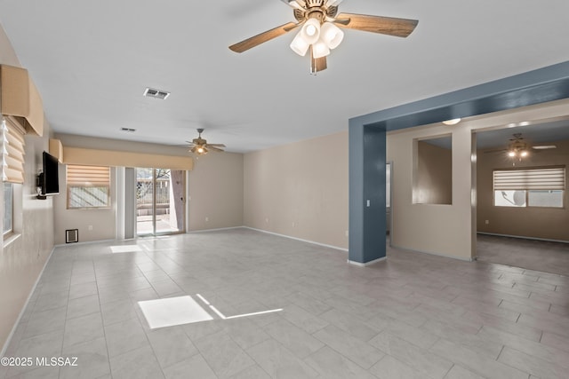 unfurnished living room featuring baseboards, visible vents, light tile patterned floors, and a ceiling fan