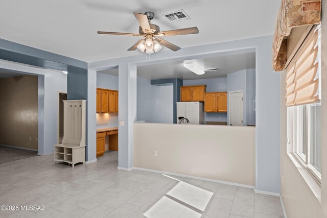 1381 W Camino Buenos Aires, Sahuarita, AZ 85629 - unfurnished living room featuring ceiling fan and baseboards
