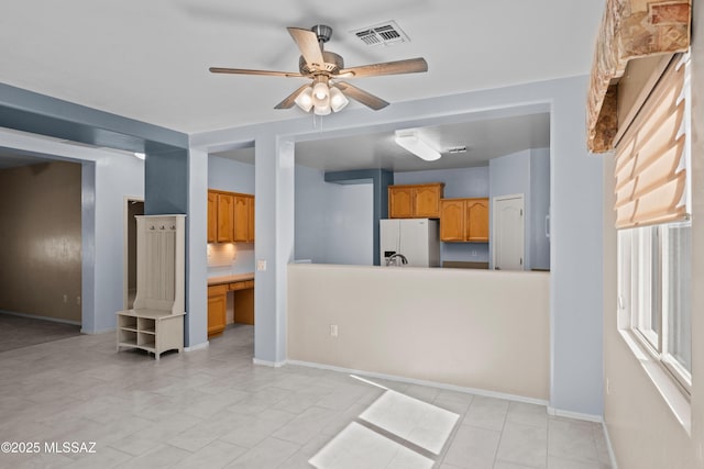 living room featuring baseboards, ceiling fan, and visible vents