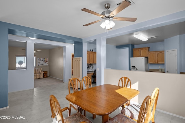 dining space with ceiling fan and visible vents