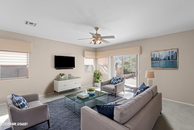 tiled living area with a ceiling fan, baseboards, and visible vents