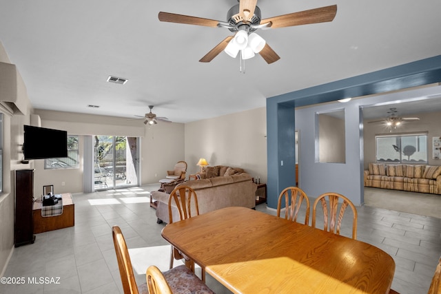 dining room featuring a ceiling fan, visible vents, and light tile patterned floors