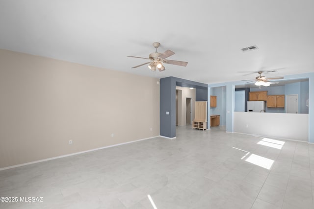 1381 W Camino Buenos Aires, Sahuarita, AZ 85629 - unfurnished living room featuring a ceiling fan and baseboards