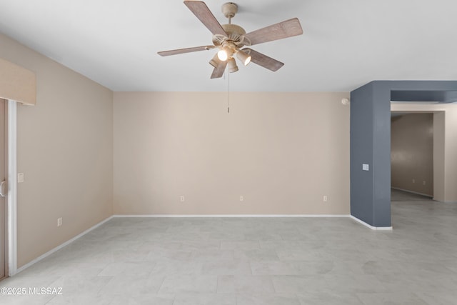 unfurnished room with baseboards and a ceiling fan