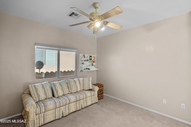 carpeted living room with visible vents, ceiling fan, and baseboards