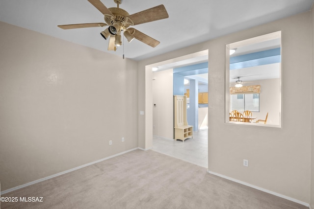 carpeted spare room featuring baseboards