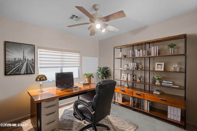 office area featuring baseboards, ceiling fan, and visible vents