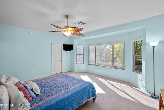 carpeted bedroom featuring baseboards, visible vents, and a ceiling fan