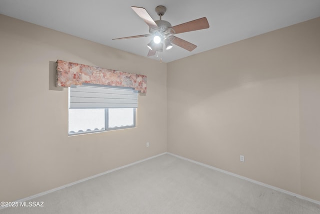 empty room featuring a ceiling fan, light carpet, and baseboards