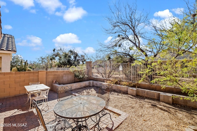 1381 W Camino Buenos Aires, Sahuarita, AZ 85629 - fenced backyard with a patio area, outdoor dining space, and a garden