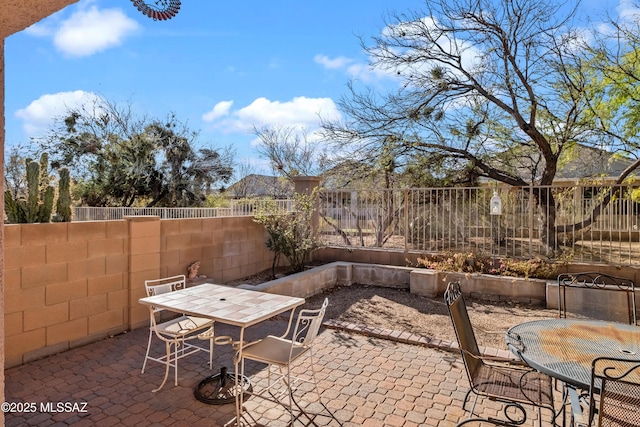 view of patio with a fenced backyard and outdoor dining space