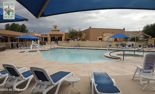 community pool featuring a patio area and fence