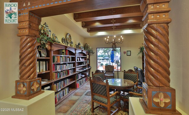 dining area featuring beamed ceiling and a notable chandelier