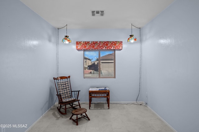 sitting room featuring visible vents and baseboards