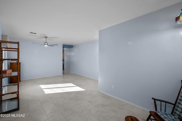 unfurnished room with baseboards, visible vents, and a ceiling fan