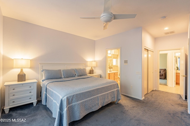 bedroom featuring dark colored carpet, visible vents, connected bathroom, and a ceiling fan