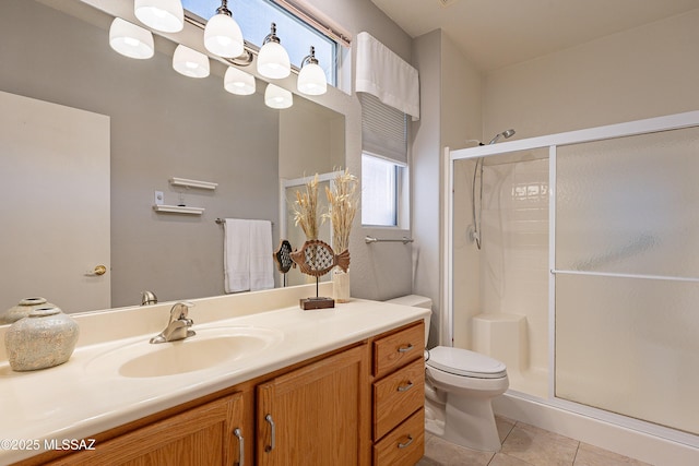 full bathroom featuring vanity, tile patterned floors, toilet, and a shower stall