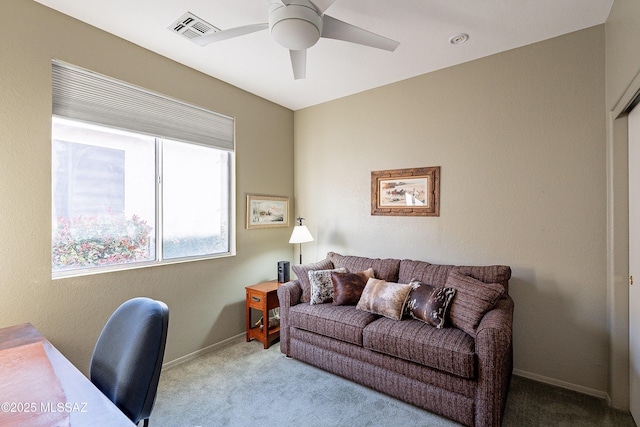 carpeted office with visible vents, baseboards, and a ceiling fan