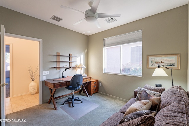 office space with visible vents, a ceiling fan, and carpet floors