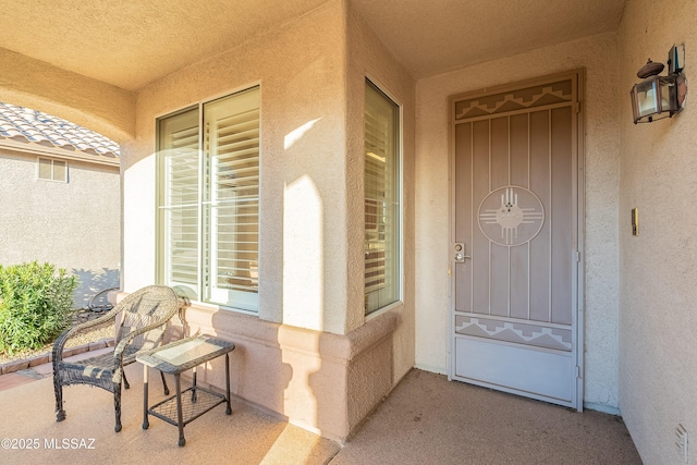 property entrance featuring stucco siding