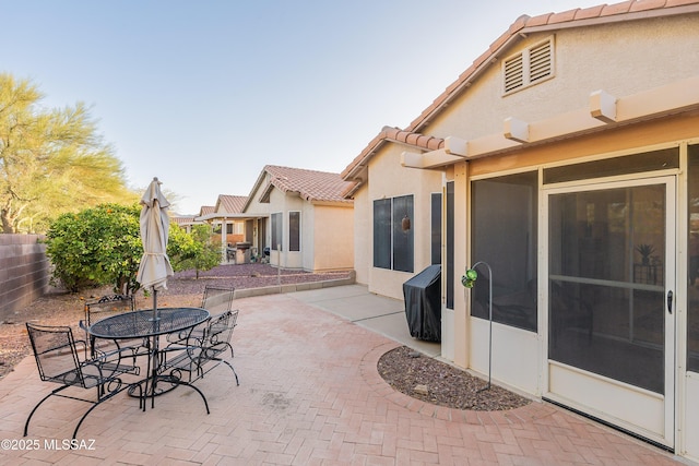 view of patio featuring outdoor dining area and fence