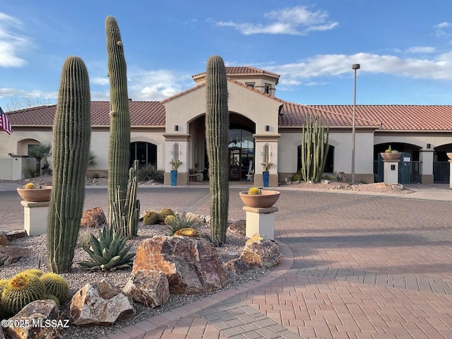 exterior space featuring stucco siding and a tile roof