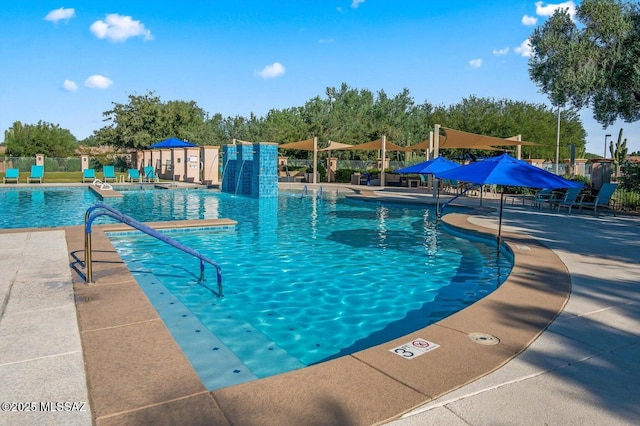 community pool featuring a patio and fence