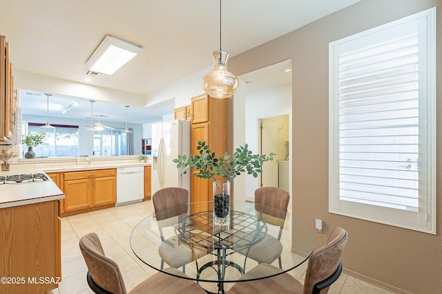 dining space featuring light tile patterned flooring and visible vents