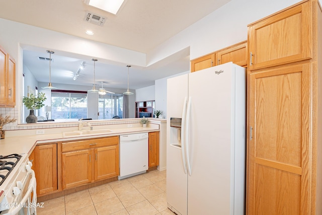 kitchen with light tile patterned floors, visible vents, white appliances, and a sink