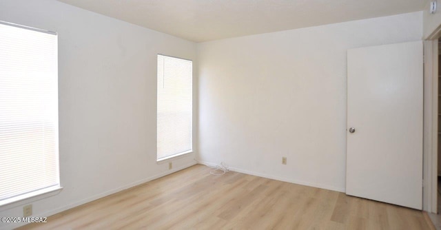 empty room featuring baseboards and wood finished floors