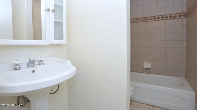 bathroom with tile patterned flooring, a sink, and toilet