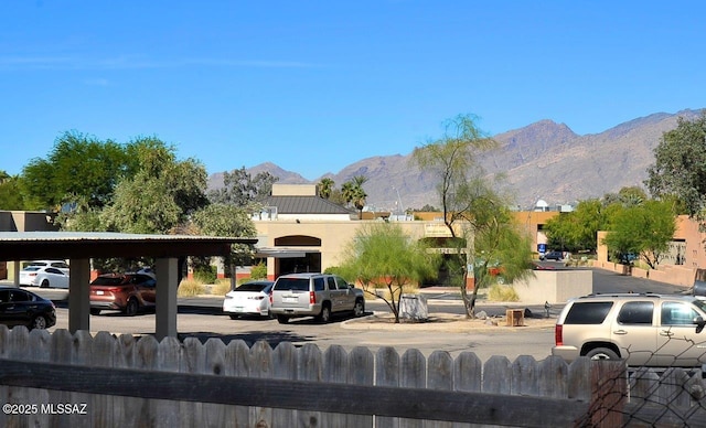 exterior space featuring fence and a mountain view