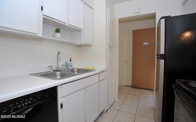 kitchen with light tile patterned floors, stainless steel appliances, a sink, white cabinetry, and light countertops