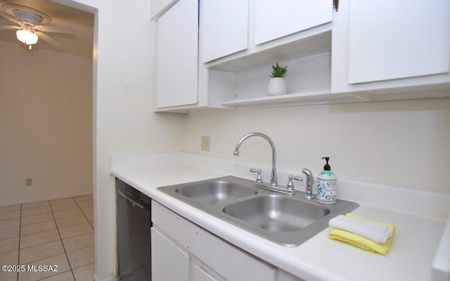 kitchen with a sink, white cabinetry, black dishwasher, light countertops, and open shelves