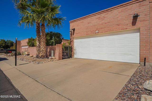 exterior space with central AC, fence, and concrete driveway