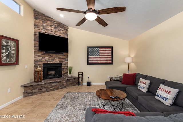 tiled living room featuring a fireplace, baseboards, vaulted ceiling, and a ceiling fan